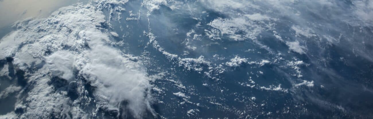 Macro view of white clouds onto of a blue planet